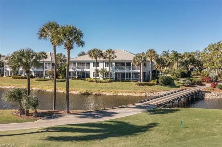 View of home's community featuring a lawn and a water view