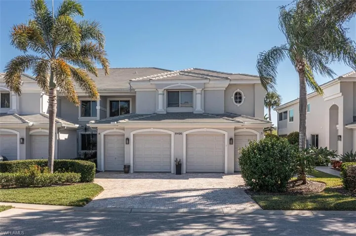 Mediterranean / spanish home with decorative driveway, a garage, stucco siding, and a tiled roof
