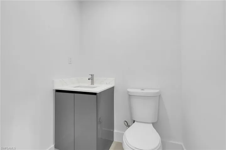 half Bathroom featuring toilet and vanity