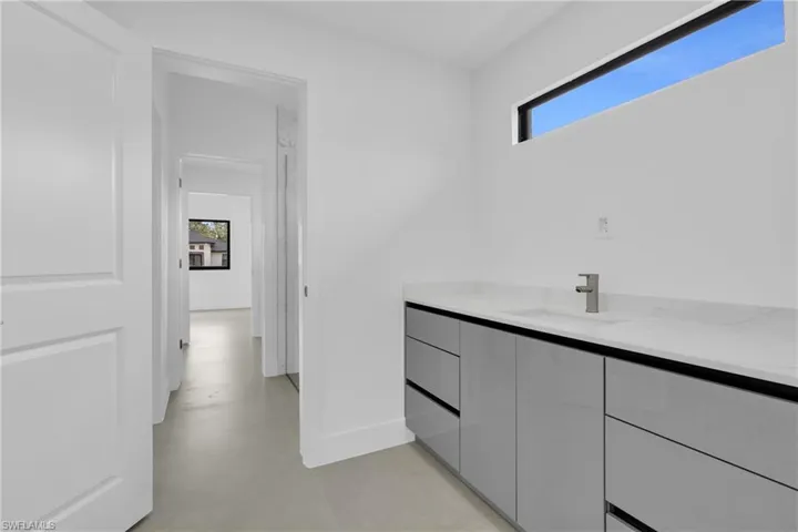 Bathroom featuring vanity and finished concrete flooring