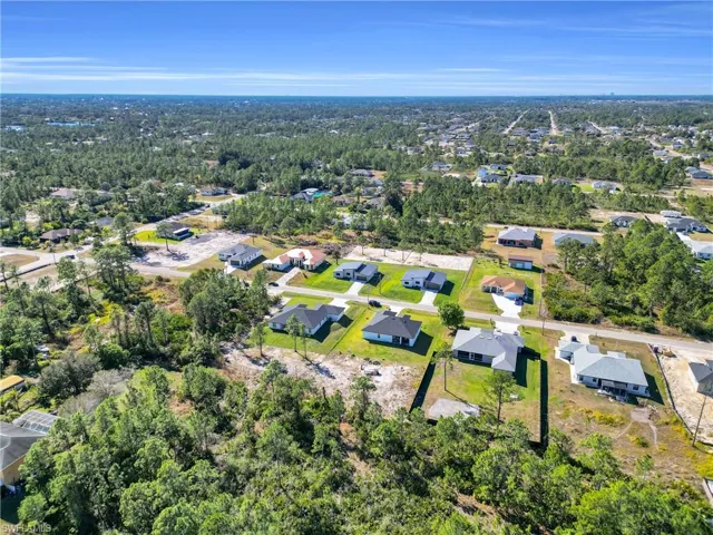 Aerial view of property's location featuring nearby suburban area