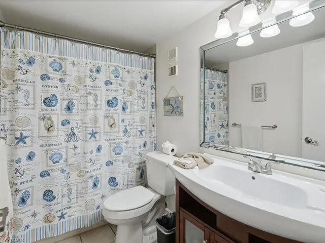 White vanity with an integrated basin, brushed nickel faucet, and wood-finish cabinetry