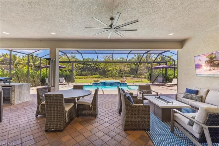 Large covered lanai space with built-in summer kitchen, pool & spa with privacy.