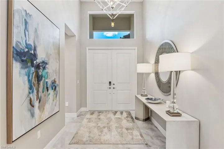 grand foyer with extravagant light fixtur