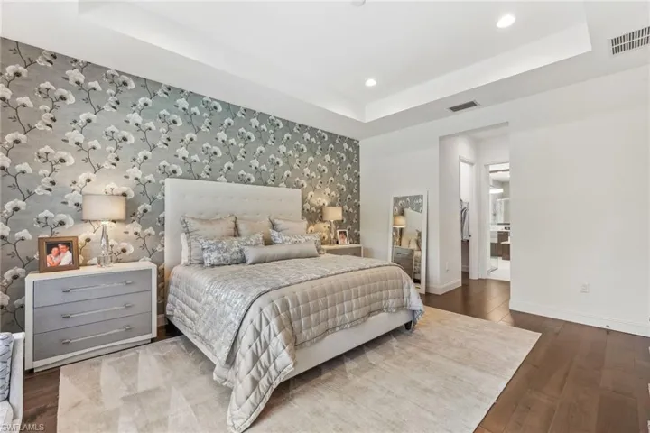 Primary master suite including engineered hardwood flooring