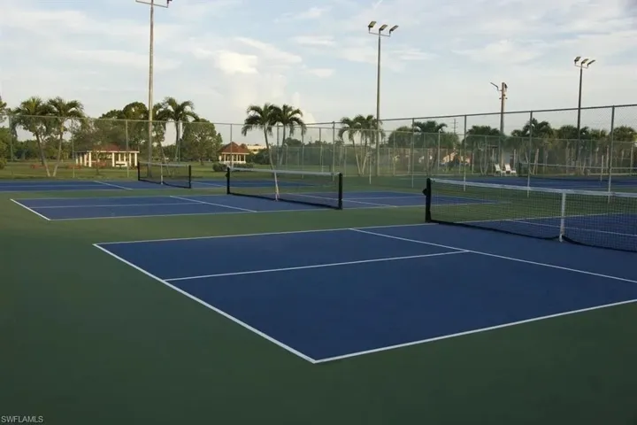 View of tennis court featuring community basketball court