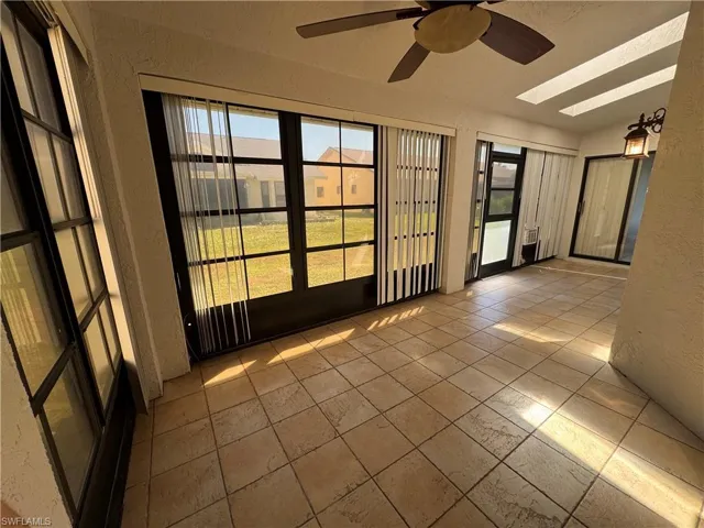 Unfurnished sunroom with a skylight