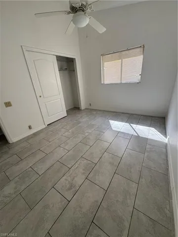 Unfurnished bedroom with a closet and ceiling fan