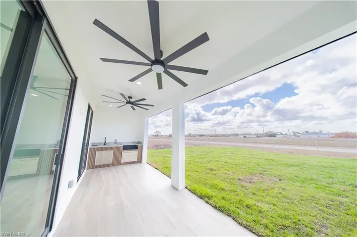 View of patio / terrace featuring a ceiling fan and an outdoor kitchen