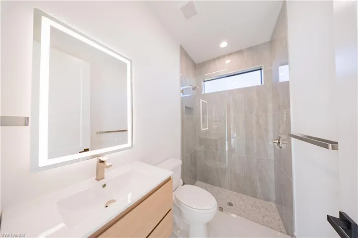 Full bathroom featuring vanity and a stall shower