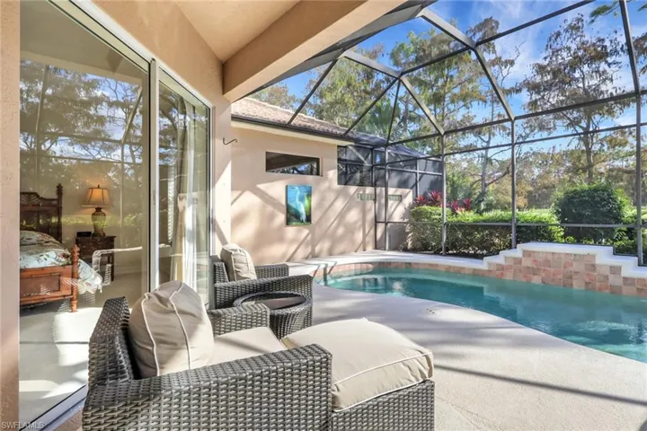 Swimming pool featuring a patio, a lanai, and a sunroom