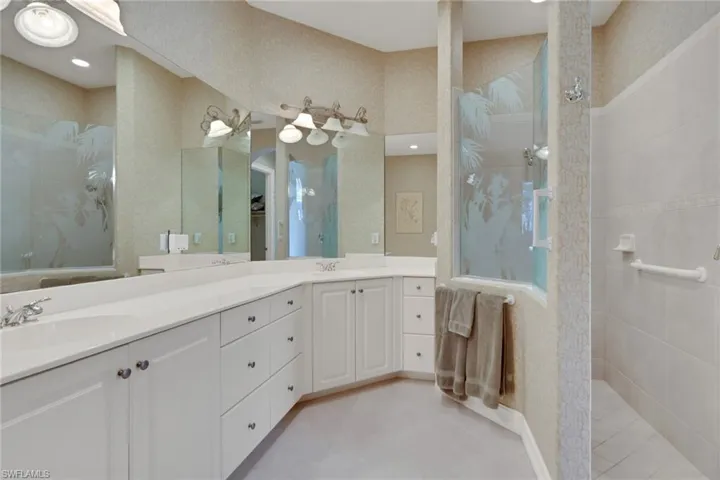 Bathroom featuring walk in shower and double vanity