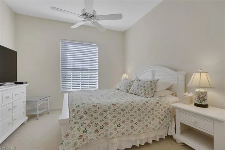 Bedroom featuring light colored carpet and ceiling fan