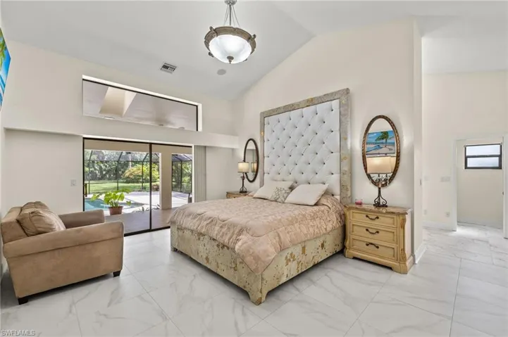 Bedroom featuring access to exterior, visible vents, marble finish floor, and multiple windows