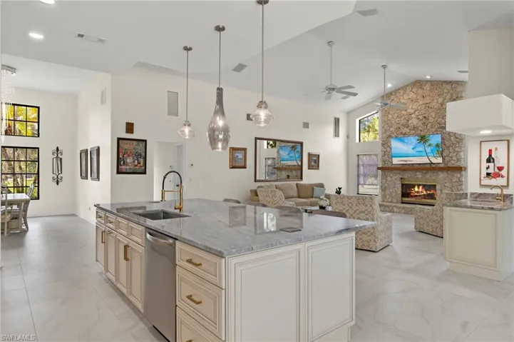Kitchen with visible vents, a sink, stainless steel dishwasher, high vaulted ceiling, and marble finish floor