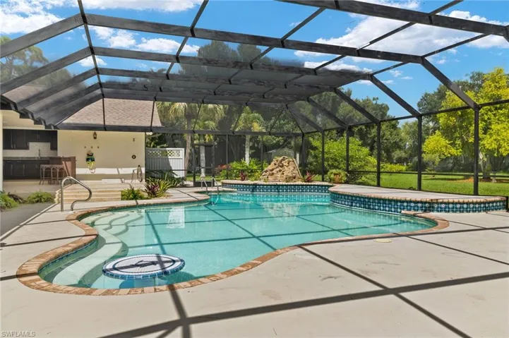 Pool with a lanai and a patio area