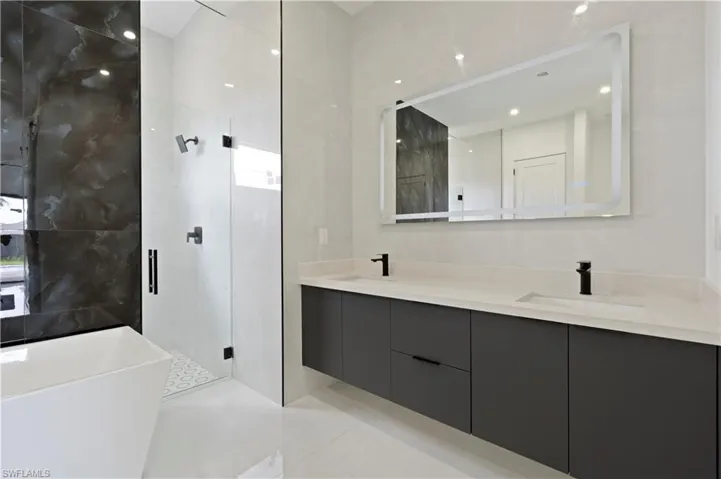 Bathroom with vanity, independent shower and bath, and tile patterned floors