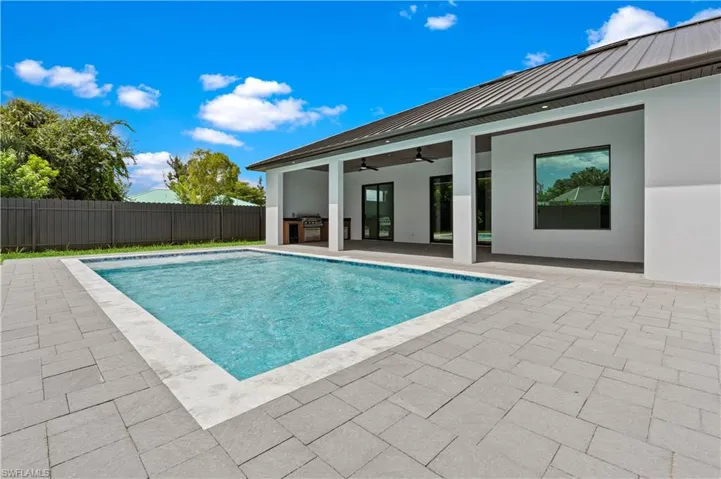 View of pool with ceiling fan and a patio area