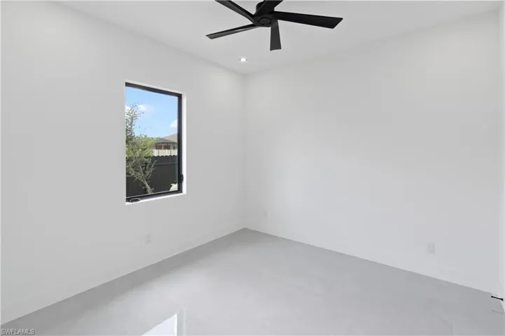 Spare room with ceiling fan