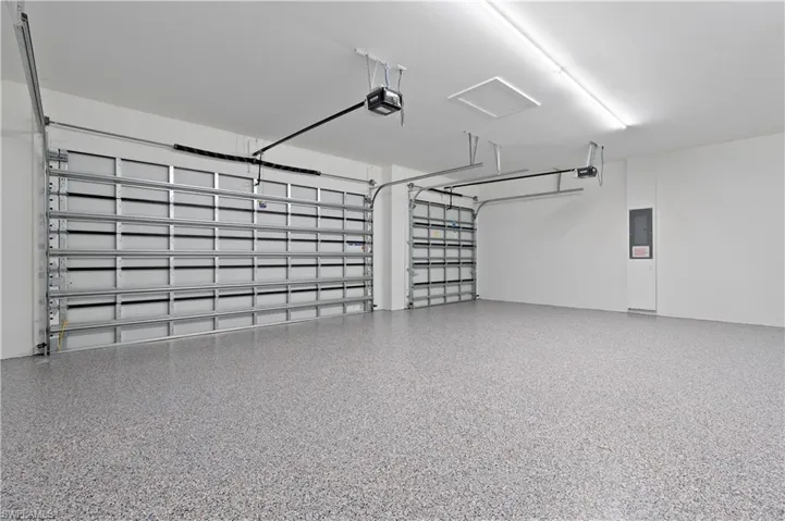 Garage with electric panel and a garage door opener