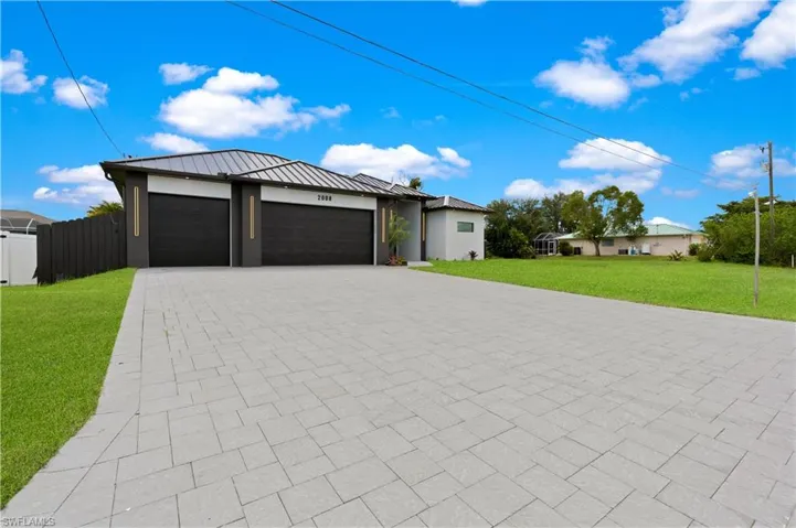 View of front of home featuring a front yard and a garage