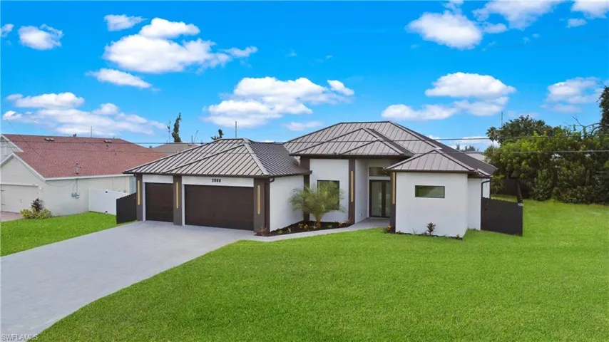 View of front of property with a front lawn and a garage