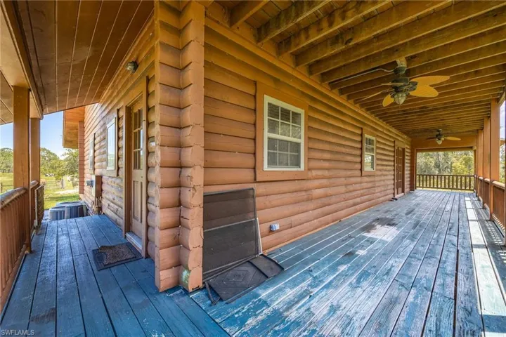 Wooden terrace featuring ceiling fan