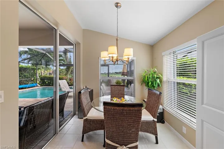 Casual dining or entertaining with views of Golf Course and Lake with fountain