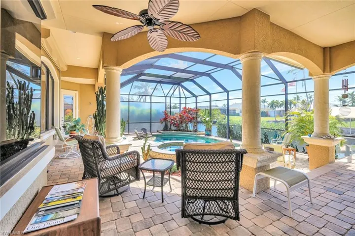 View of patio / terrace with glass enclosure, a sunroom, and a ceiling fan