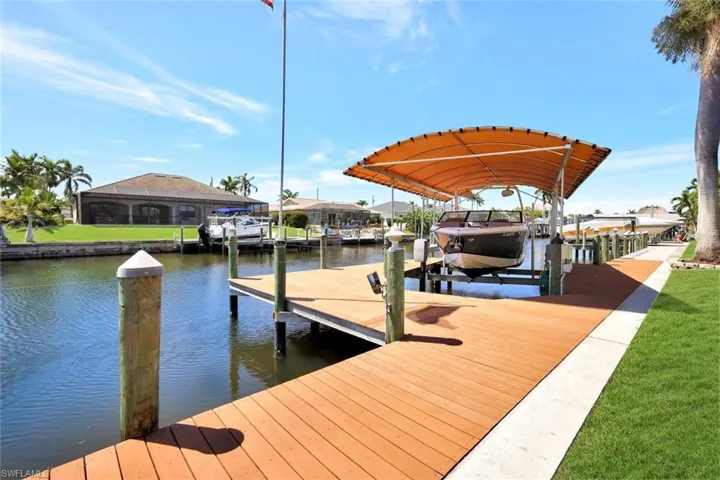 Dock area featuring boat lift and a water view