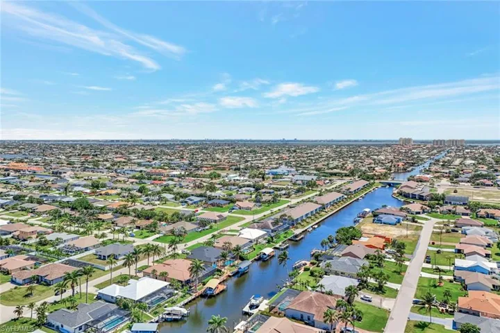 Aerial view of residential area featuring a large body of water