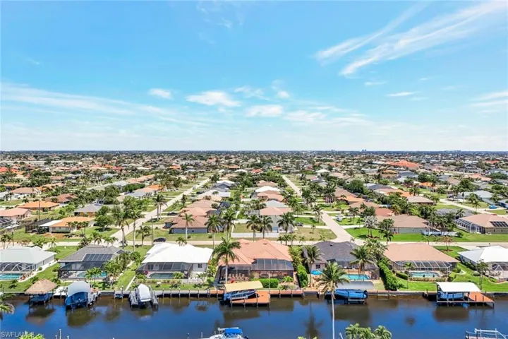 Aerial view of residential area featuring a nearby body of water
