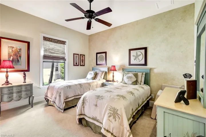 Bedroom featuring light carpet and ceiling fan