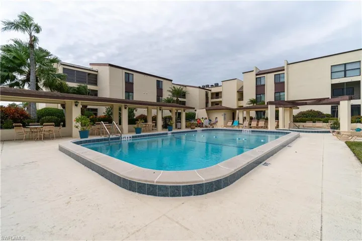 View of swimming pool with a patio area and a pergola