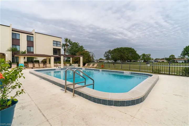 View of pool with a pergola and a patio