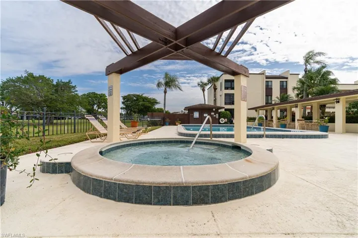 View of swimming pool with a community hot tub and a patio