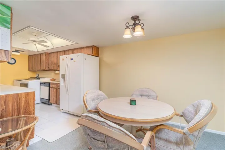 Dining room featuring washer / clothes dryer, ceiling fan, and light tile patterned floors