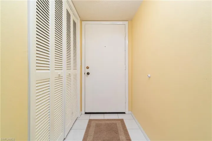 Doorway featuring light tile patterned floors