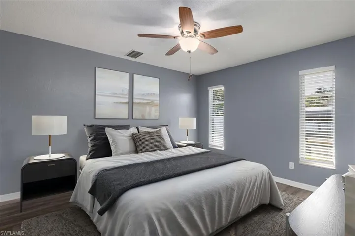 Bedroom featuring wood finished floors, a ceiling fan, and a textured ceiling