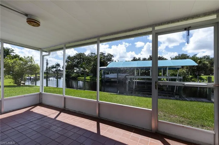 Unfurnished sunroom featuring a water view