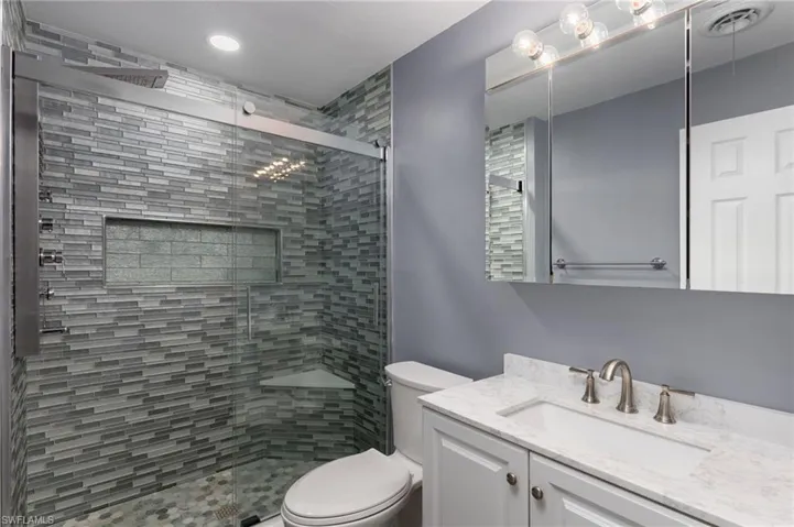 Bathroom featuring vanity and a shower stall
