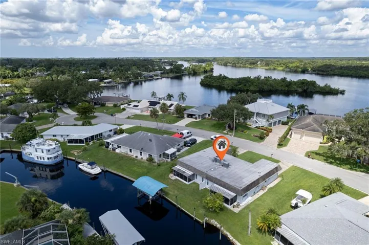 Aerial perspective of suburban area featuring a large body of water