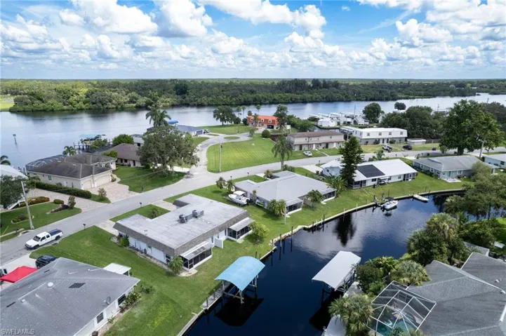 Aerial view of residential area featuring a nearby body of water