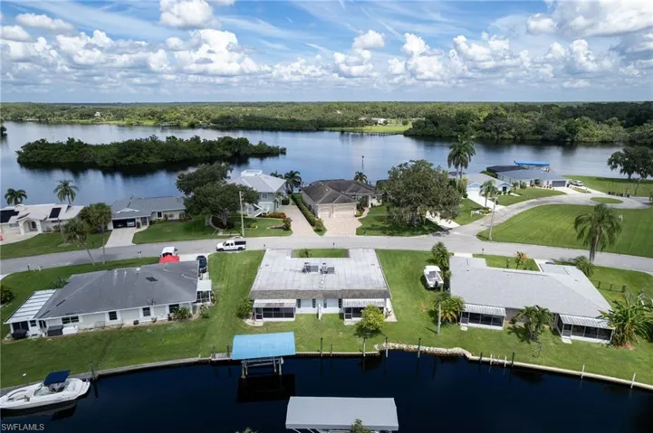 Aerial perspective of suburban area featuring a nearby body of water
