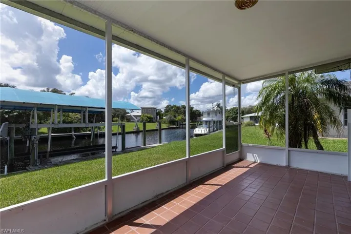 Unfurnished sunroom with a water view
