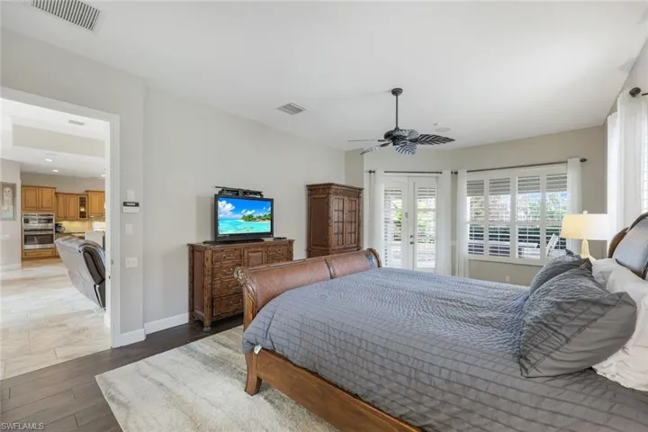 Bedroom featuring ceiling fan, wood-type flooring, access to outside, and french doors