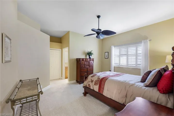 Bedroom featuring ceiling fan and light carpet