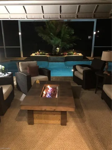View of swimming pool with an outdoor living space with a fire pit