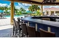 View of patio / terrace featuring exterior bar and a community pool