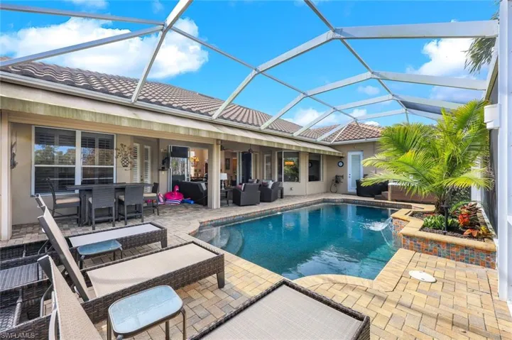 View of pool featuring  outdoor living space, pool water feature, and a patio